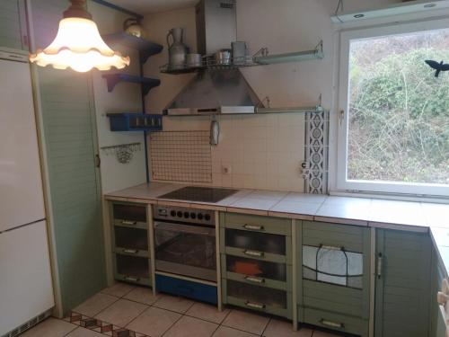 a kitchen with a stove and a window at In Kadenbach, Schöne Ferienwohnung im ruhigen in Kadenbach