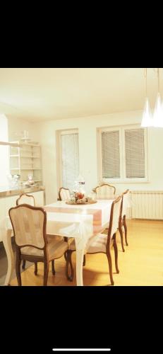 a dining room with a table and four chairs at Lilia apartment in Zagreb