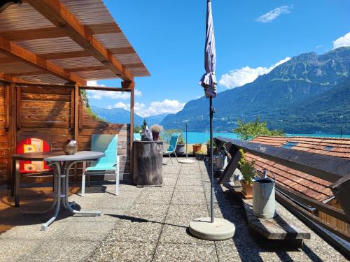 a patio with a view of a lake and mountains at Chalet Diana Lakefront in Ringgenberg