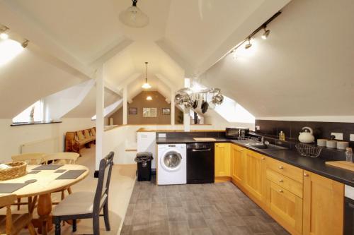 a kitchen with a washer and dryer in it at Stable Cottage in Ross on Wye