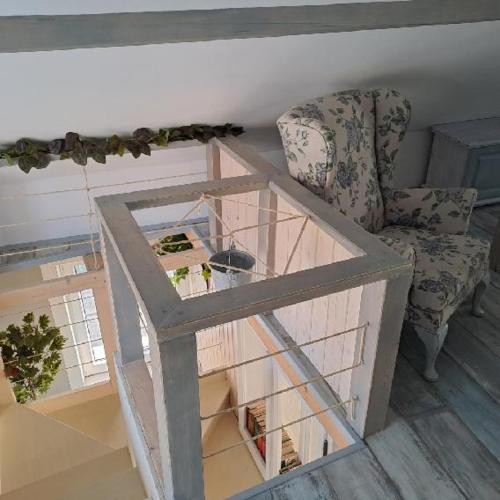 a bird house with a chair and a glass table at NAD STARÝM SKLEPEM in Valtice