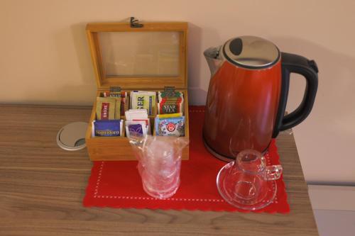 a table with a tea pot and a pitcher on it at Brettia Guest Rooms in Cosenza