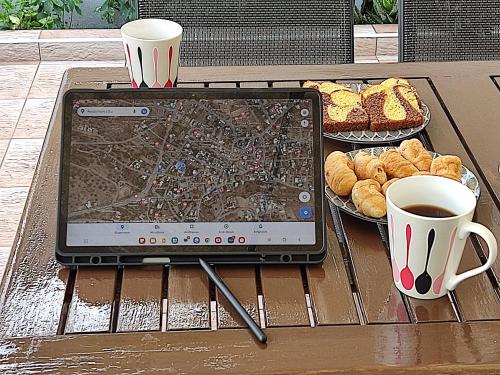 a laptop computer sitting on a table with a cup of coffee at Irini's Home - Pitsidia in Pitsidia