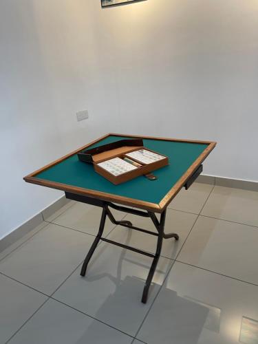 a green table with a book on top of it at KY Happiness Homestay Tanjong Karang 快乐民宿 in Tanjung Karang