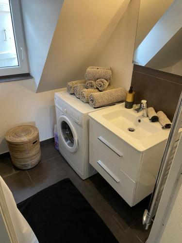 a bathroom with a washing machine and a sink at SECRET MAMA with Aircon 150 meters from parking Rapp in Colmar