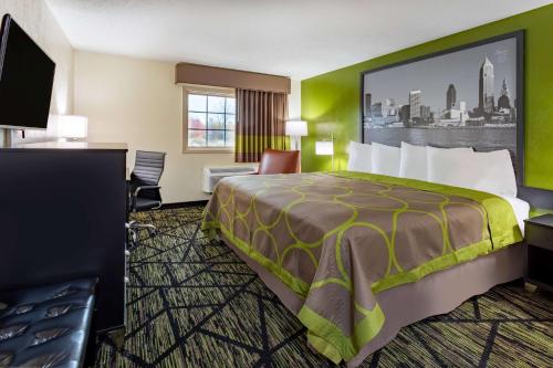 una habitación de hotel con una cama y un escritorio en Super 8 by Wyndham Wooster, en Wooster