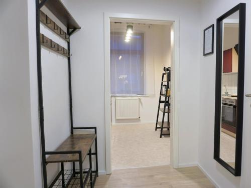 a hallway with a mirror and a table and chairs at "HOGULU" Brandenurg Neustadt, Balkon, Küche, Wassernähe in Brandenburg an der Havel