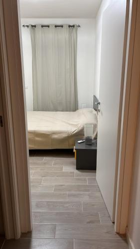 a bedroom with a bed and a table with a window at Owen Home Holiday in Castelsardo