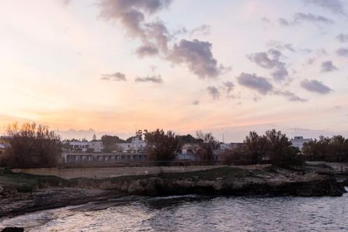 a sunset over a river with buildings in the background at Casa Mar y Sol in Torre a Mare