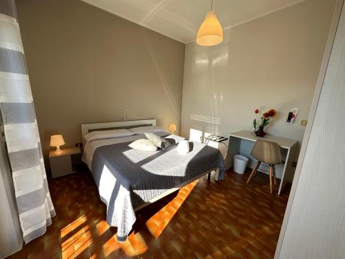 a bedroom with a bed and a desk at Hotel Miura in Cavalcaselle