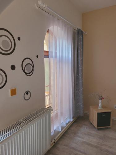 a room with a window with white curtains at Apartmány Brno in Brno