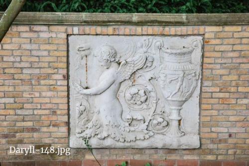 a statue of a woman holding a vase on a brick wall at The Dairy in Sutterton