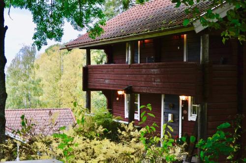 a large wooden house with a balcony on the side at Villa Franca Maria in Rättvik