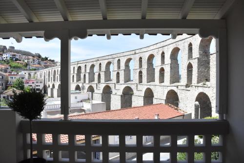 a view of a large building from a window at Plinthos Residence in Kavala