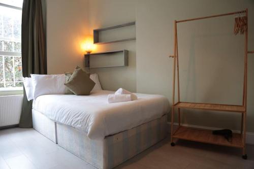 a bedroom with a white bed and a window at Cosy Chic Studio in King's Cross in London
