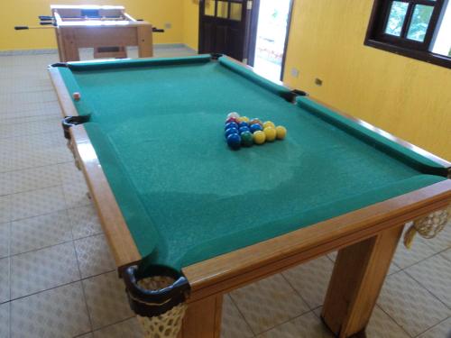 a pool table with balls on top of it at Pousada Boramar in Boracéia