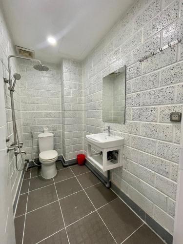 a white bathroom with a sink and a toilet at Aspire Saigon - Ly Tu Trong in Ho Chi Minh City