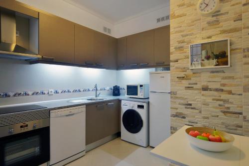 a kitchen with a bowl of fruit on a table at FLH Bairro Alto - Chiado Spacious Flat in Lisbon