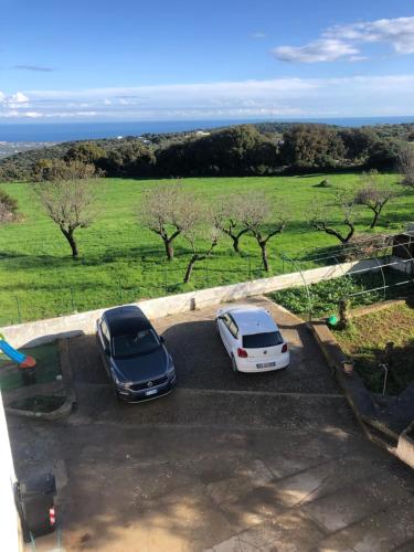 two cars parked in a parking lot in a field at Terrazza Dolce Vista in Monopoli