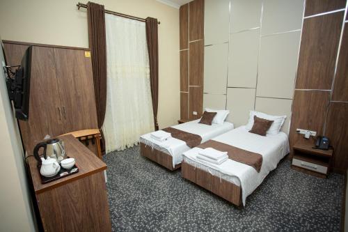 Un ou plusieurs lits dans un hébergement de l'établissement Rayyan Hotel Samarkand