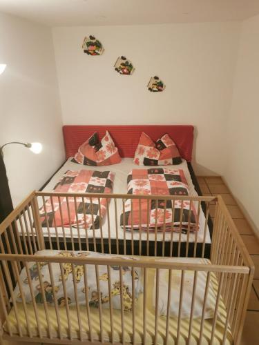 a crib in a bedroom with presents on it at Studio Mario in Alberschwende