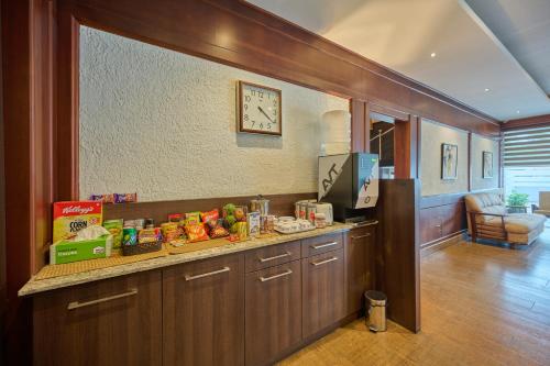 cocina con encimera con reloj en la pared en Nettoor Pavilion, en kumbalam