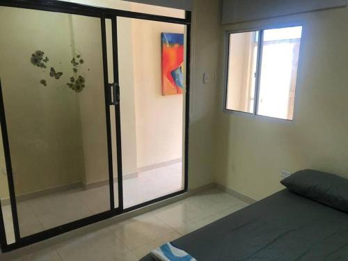 a room with a glass door and a window at Apartamento para 5 in Barranquilla