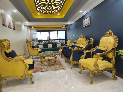 a room with gold furniture and a living room at شقق المنيل in Cairo