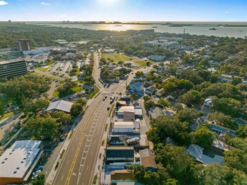 an aerial view of a city with a road and buildings at Welcome to Cozy Coastal Cottages of Dunedin #1 in Dunedin