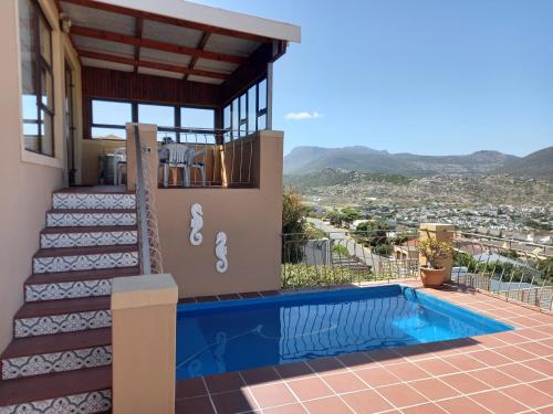 a villa with a swimming pool and a house at A Place in Thyme in Fish hoek