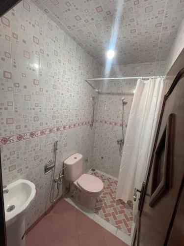 a small bathroom with a toilet and a sink at Fully equipped ground floor apartment in Safi