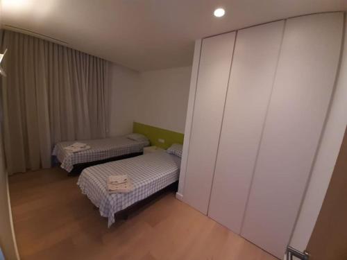 a small room with two beds and a wall at Camiral Golf and Wellness Luxury Villa in Girona