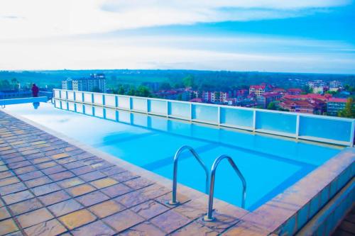 a swimming pool on the roof of a building at LaMeg2 Furnished Studio with Pool - Kiambu Rd in Nairobi