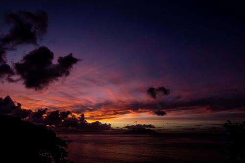 a sunset over a body of water with at Treasure Cove Hotel & Restaurant in Bel Ombre