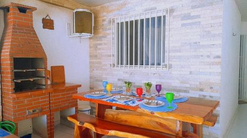 a dining room with a table and a fireplace at Casa com piscina em Carapibus - Jacumã in Conde