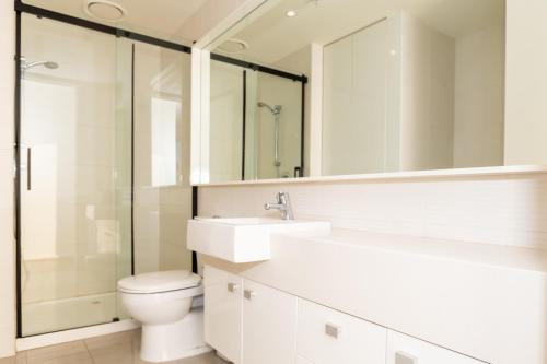 a bathroom with a toilet and a sink and a shower at Jade Resorts Melbourne in Melbourne