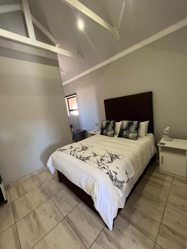 a bedroom with a large bed in a room at Zen Stone Guest House in Postmasburg
