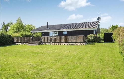 a house with a grass yard in front of it at 2 Bedroom Nice Home In Samsø in Nordby