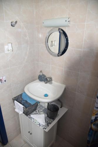 a bathroom with a sink and a mirror at Relaxing and Comfortable Studio Near Falasarna Beaches in Plátanos