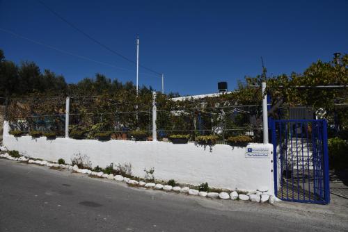 a fence with a blue gate on the side of a street at Relaxing and Comfortable Studio Near Falasarna Beaches in Plátanos