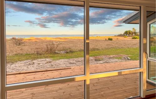 a view of the ocean from a house window at Gorgeous Home In Samsø With Kitchen in Nordby
