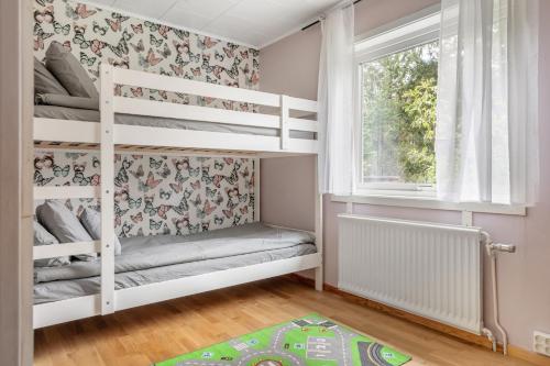 a childs bedroom with bunk beds and a window at Peaceful holiday home surrounded by nature in Töllsjö