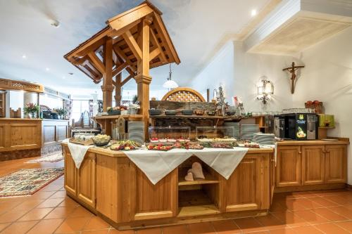 a kitchen with a table with food on it at Hotel Breitlehenalm in Obertauern
