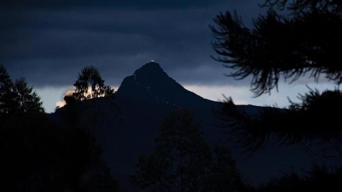 a silhouette of a mountain at night with the sky at Grand Argyle Resort in Hatton