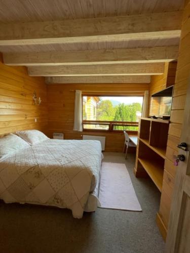 a bedroom with a bed and a large window at B&B de German in Pucón