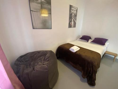 a room with two beds and a bean bag chair at Apartamento en Madrid Rio con Parking Gratuito in Madrid