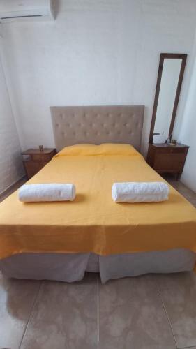 a bedroom with a bed with two towels on it at El Fondo in Guaymallen