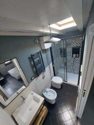 a bathroom with a sink and a toilet and a mirror at Casa Vacanze Malvarosa in Spigno Saturnia