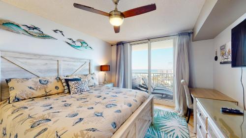 a bedroom with a bed and a large window at Sunset Haven in Destin