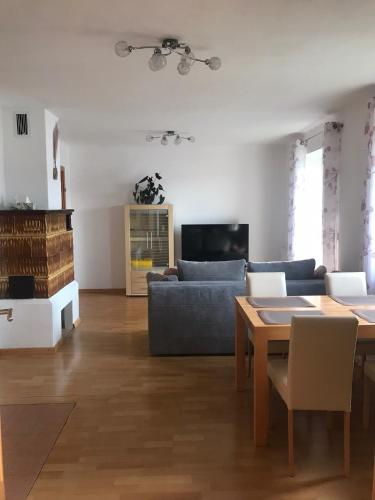 a living room with a couch and a table at Ferienwohnung Lechnerhof in Tiefgraben